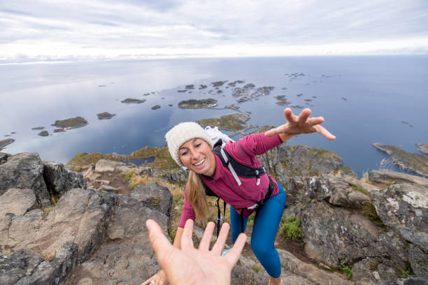 istock Hiker helping teammate to reach mountain top, summit 1746244770