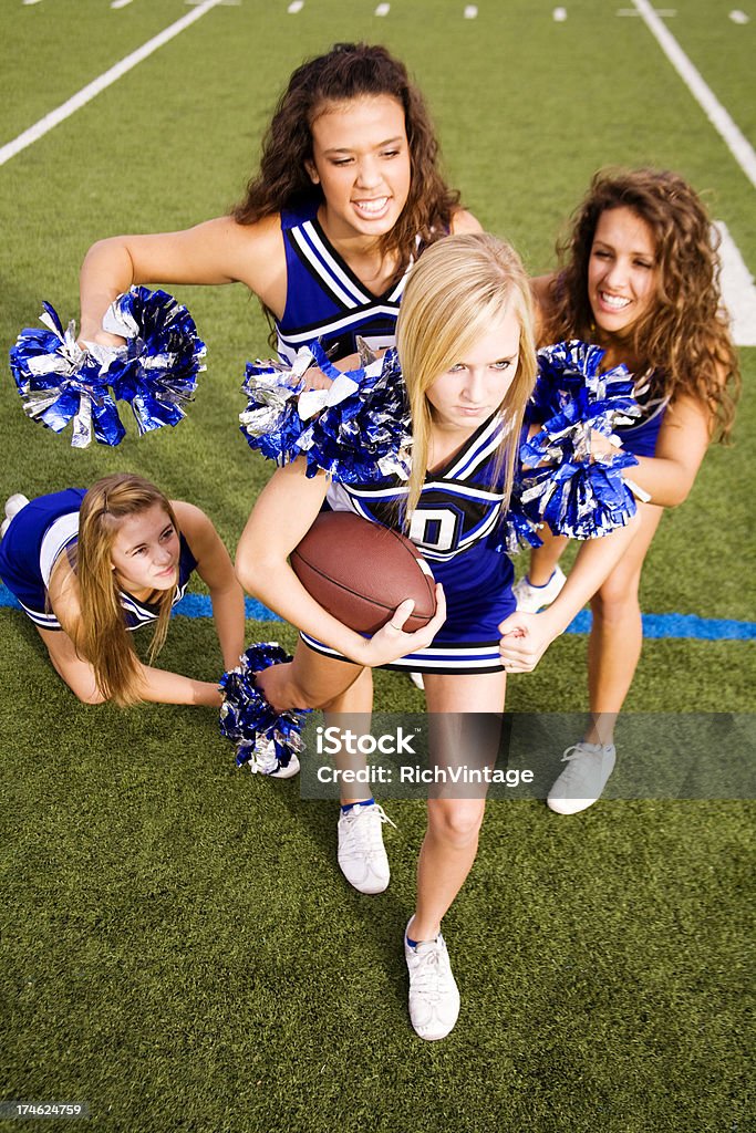 Tackle the Cheerleader These cheerleaders want to play real football, not the powder-puff version. 18-19 Years Stock Photo