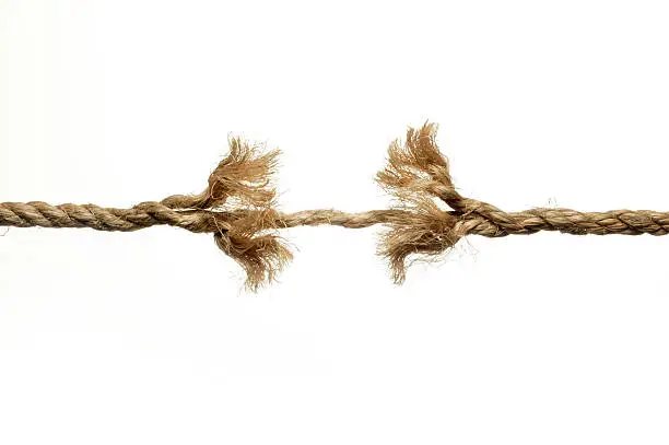 A frayed rope unraveling against a white background. 