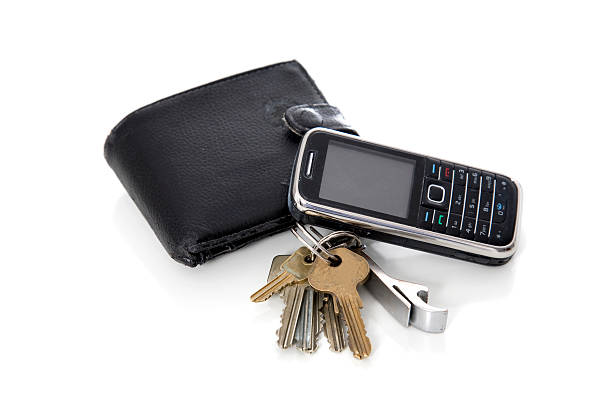 Wallet,keys and phone. A man's wallet keys and mobile phone isolated on white. phone wallet keys stock pictures, royalty-free photos & images