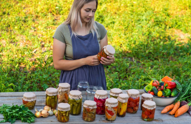 istock A woman preserves vegetables in jars. Selective focus 1746252302