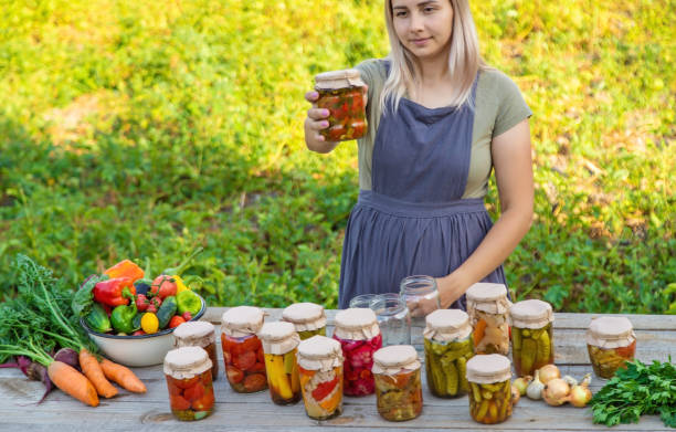 istock A woman preserves vegetables in jars. Selective focus 1746252410