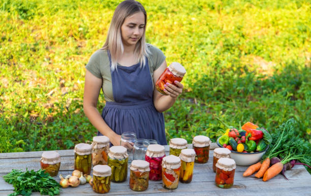 istock A woman preserves vegetables in jars. Selective focus 1746252628