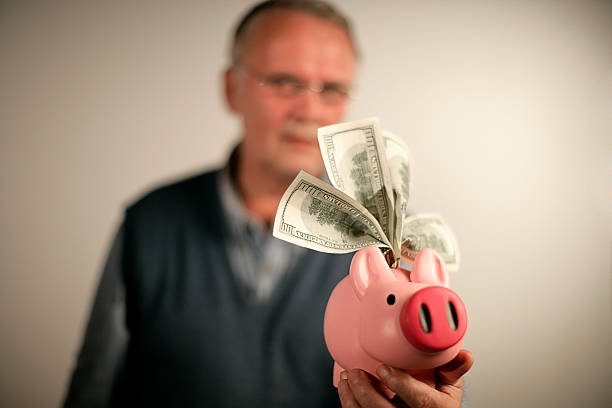 istock Senior with Piggy Bank 174625304