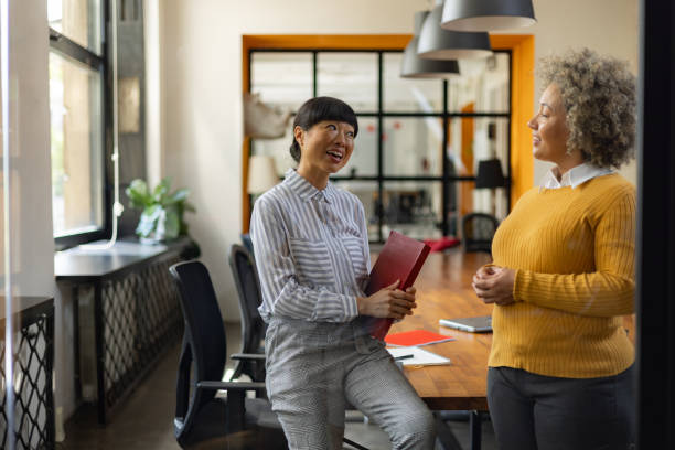 istock Happy businesswomen communicating in the office. 1746257046