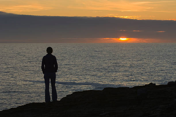 istock Young woman watching sunset 174625720