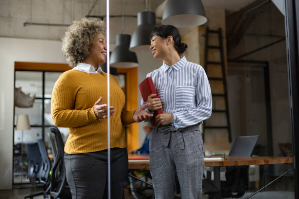 istock Happy business colleagues talking in the office. 1746258226