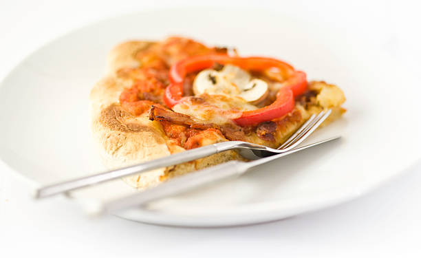 Single slice of pizza on plate stock photo