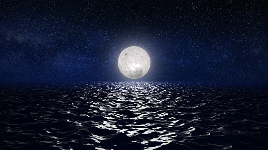 Full moon in the dark sky above the water