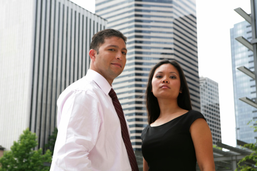 Business people standing in front of office buildings