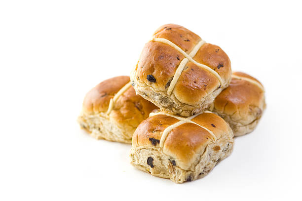 A batch of hot cross buns on a white background stock photo