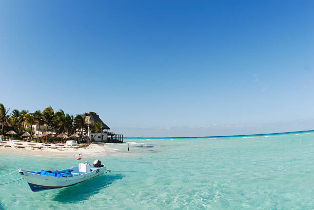 Beautiful beach with golden sand and blue water, Caribbean Sea, Mexico.