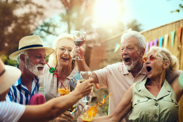 istock Cheerful seniors toasting on a party in the backyard. 1746275872
