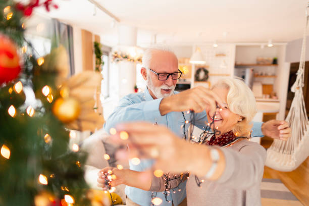istock Senior couple decorating home for Christmas 1746282312