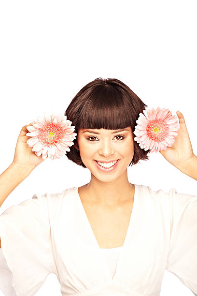 istock Woman Playfully Holding Flowers by her Head 174628365