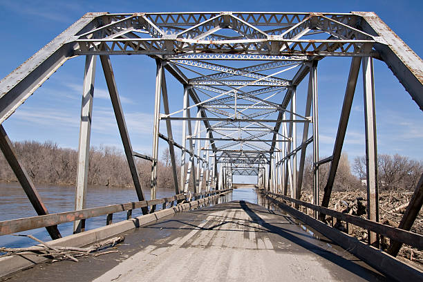 istock old steel bridge and flooding river 174629022