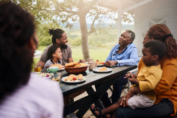 istock Happy black extended family talking while having a meal at patio. 1746293000