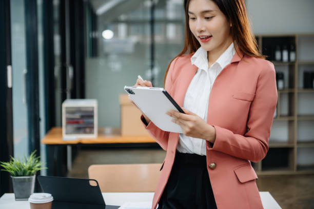 istock Asian businesswoman working in the office with working notepad, tablet and laptop documents 1746293873
