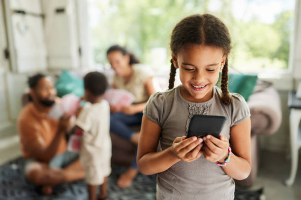 istock Happy black girl using cell phone at home. 1746296294