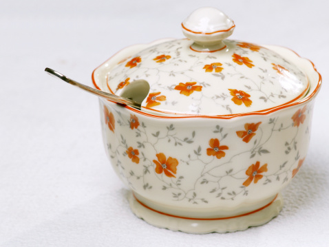 close-up of a porcelain sugar bowl with floral decor