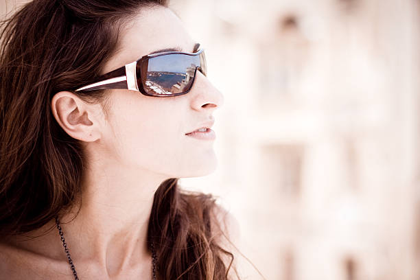 istock young woman with sunglasses 174630057