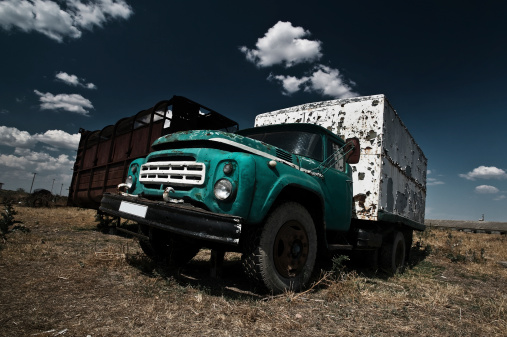 An old abandoned truck on some deserted field