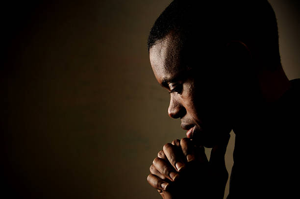 Prayer Young man praying. saying grace stock pictures, royalty-free photos & images