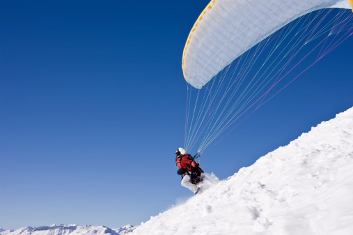 Paraglide Launch high above alpine Peaks.