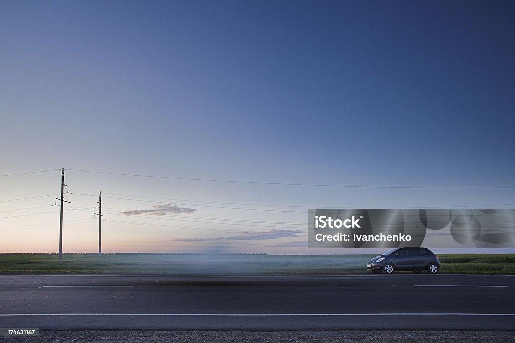 Roads of life A small car standing on the side of the road in the middle of a beautiful tranquil scene Abandoned Stock Photo