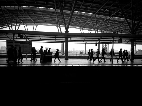 Jakarta, Indonesia, 05 August 2023 ; Train station building background and silhouettes of people rushing