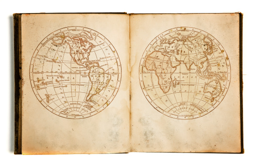 Ancient map of Europe reproduced on a wooden Earth globe for first explorers. Compass is positioned in the middle of Atlantic Ocean, with old writings, navigational coordinates and country borders. Spain, United Kingdom, France, Italy, Germany, Greece and Turkey are visible, together with North Africa and Middle East.