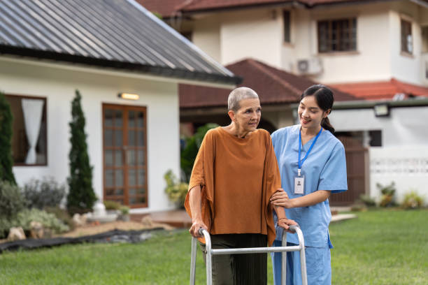 istock Nurse or caregiver help elderly walk by using walker in garden 1746315284