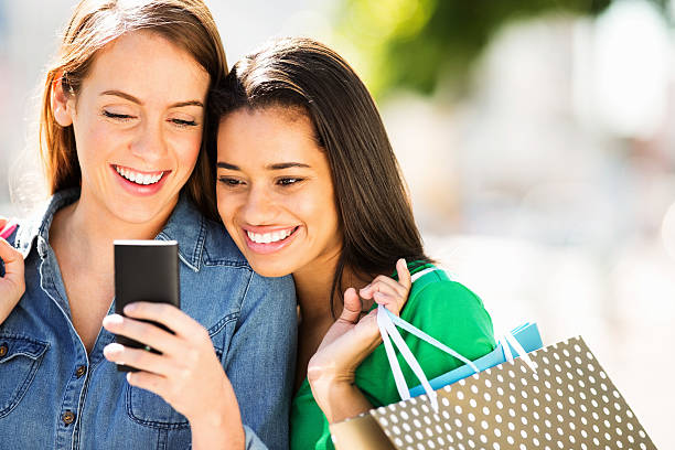 istock Happy Friends With Shopping Bags Reading Text Message 174631857