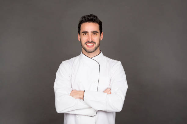 istock young chef man smiling looking at camera with arms crossed 1746322818