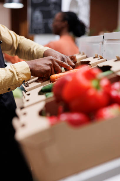 istock Person arranging carrots in a box 1746324496