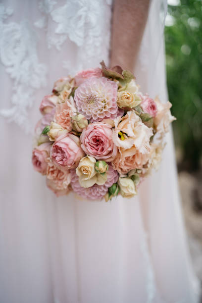 istock the bride holds a pink wedding bouquet in her hand 1746325021