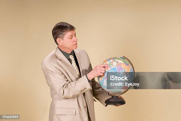 Businessman Teacher Points At Saudia Arabia On Globe Stock Photo - Download Image Now