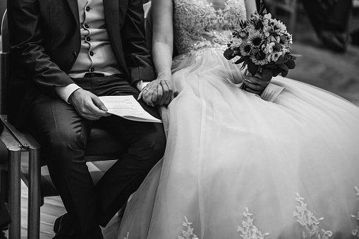 bridal couple holding hands during ceremony in church
