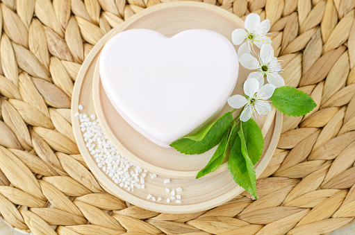 Heart shaped bar of soap (solid shampoo). Natural beauty treatment, hair care or zero waste concept. Top view, copy space.