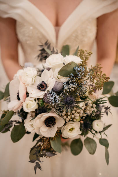 istock the bride holds a wedding bouquet with white flowers in her hand 1746329079