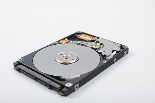 Hard drive, open, interior with trays and head, on white background,
