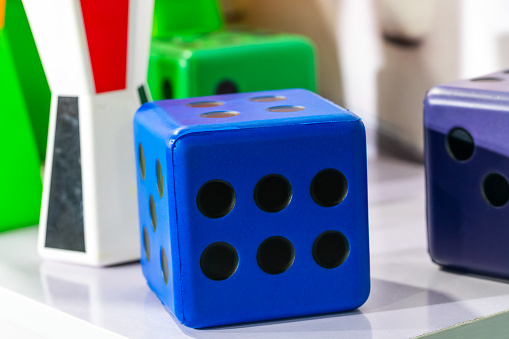 Blue cube and some colorful children's toys