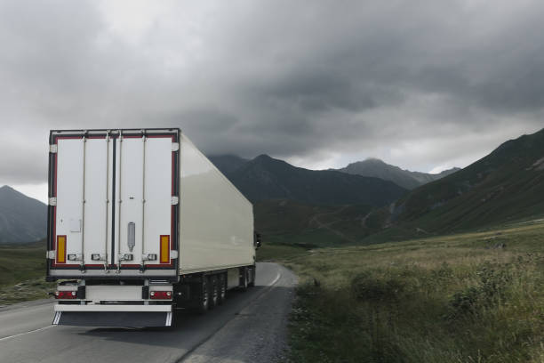 istock semi truck driving through mountain road pass 1746337178