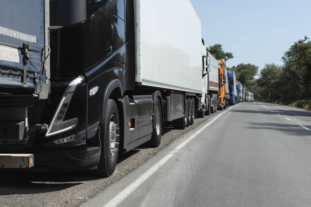 istock semi trucks waiting in a row near border. traffic jam. 1746337208
