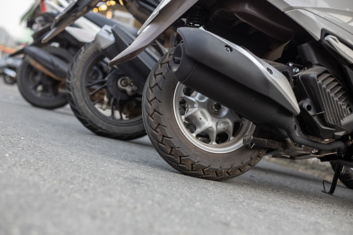 Detail shot of a biker's gloved hands on motorcycle handlebars, ready to ride.