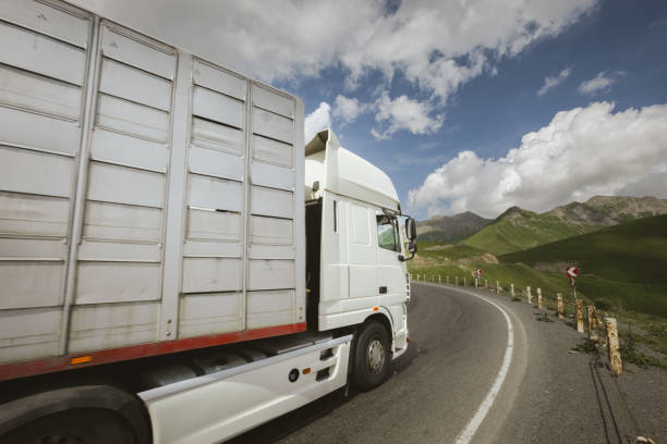 istock frieght truck driving through mountain road pass 1746338366