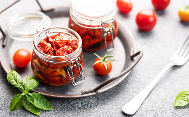 istock Jars with sun dried tomatoes with fresh herbs and spices. 1746339073