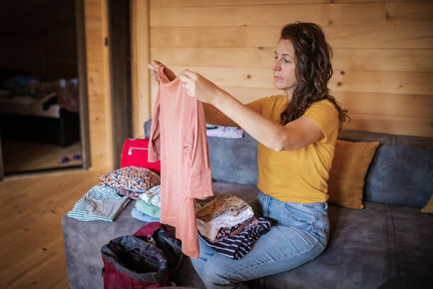 istock Young woman is packing her stuff in backpack. She is ready for a trip and new adventure. 1746341309