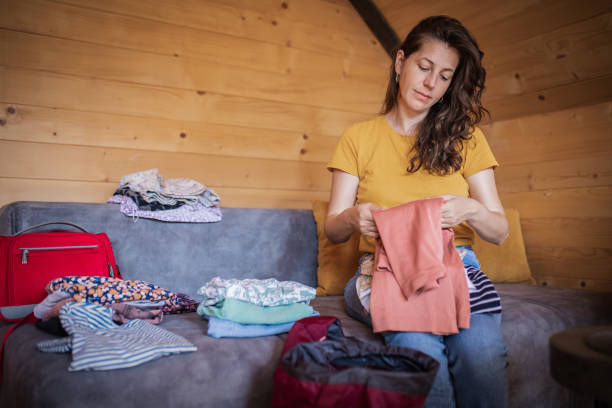 istock Young woman is packing her stuff in backpack. She is ready for a trip and new adventure. 1746341320
