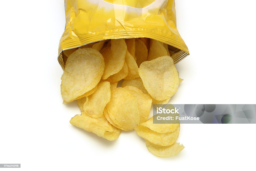 Chips spilling out of an open bag Bag of golden chips isolated on a white background. Potato Chip Stock Photo